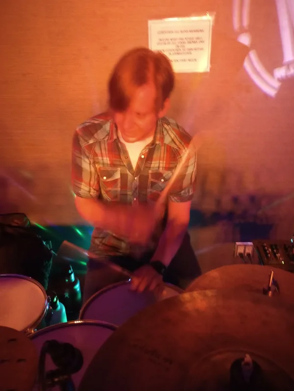 Chad Eisinger playing drums at a live performance