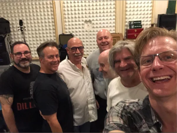 Chad Eisinger with fellow musicians in a recording studio